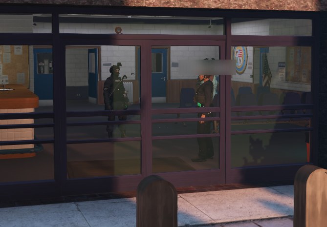 Officers in tactical gear inside the Mission Row police station lobby